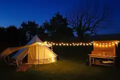 Goldfinch bell tent at night with a private outdoor kitchen Goldfinch bell tent at night with a private outdoor kitchen