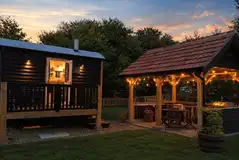 Outdoor kitchen and BBQ area for the Kestrels Rest shepherd's hut at dusk Outdoor kitchen and BBQ area for the Kestrels Rest shepherd's hut at dusk