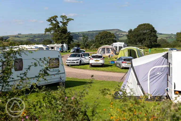 Grass pitches with space for a parked car at The Dorset Hideaway
