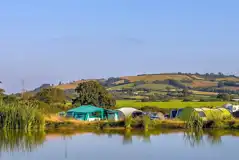Camping field by the fishing pond at The Dorset Hideaway