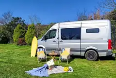 Grass pitch with a 16 amp hook up for tourers at Cambrose Camping and Touring