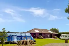 Grass pitches with optional electric by the facilities block