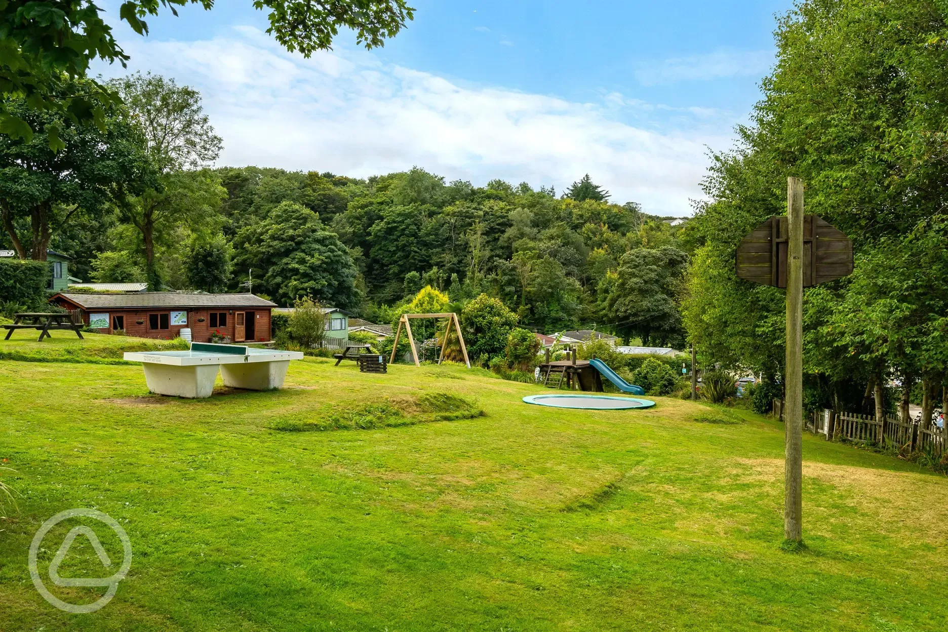 Outdoor recreation area with table tennis and a trampoline