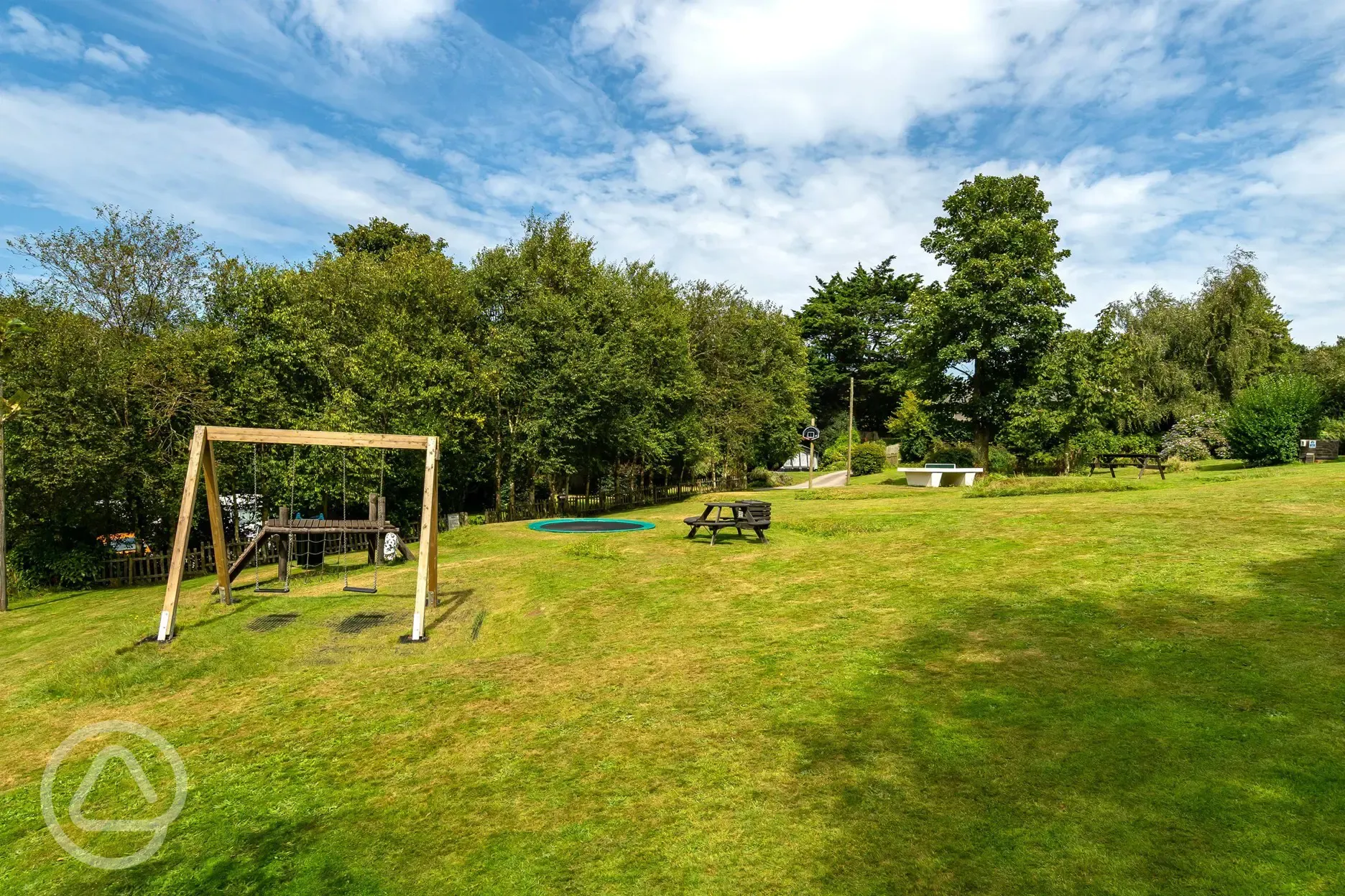 Outdoor recreation area with table tennis and a trampoline