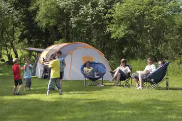 Family playing by their tent