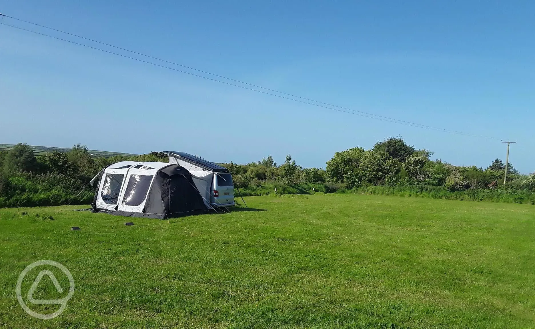 Large grassy pitch at Higher Cheristow Farm Campsite 