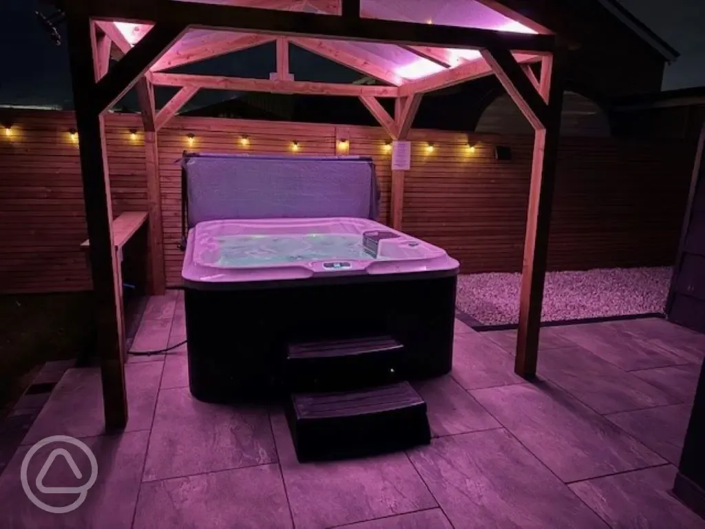 Ensuite glamping pod hot tub at night