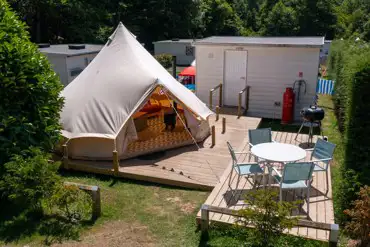Ensuite bell tent with decking and outdoor furniture at Bluebell Coppice Park