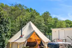 Ensuite bell tent with decking and outdoor furniture at Bluebell Coppice Park