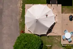 Bird's eye view of a bell tent with decking, private furniture, and a BBQ