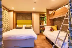 Glamping pod interior with a double sofa bed and bunk beds Glamping pod interior with a double sofa bed and bunk beds
