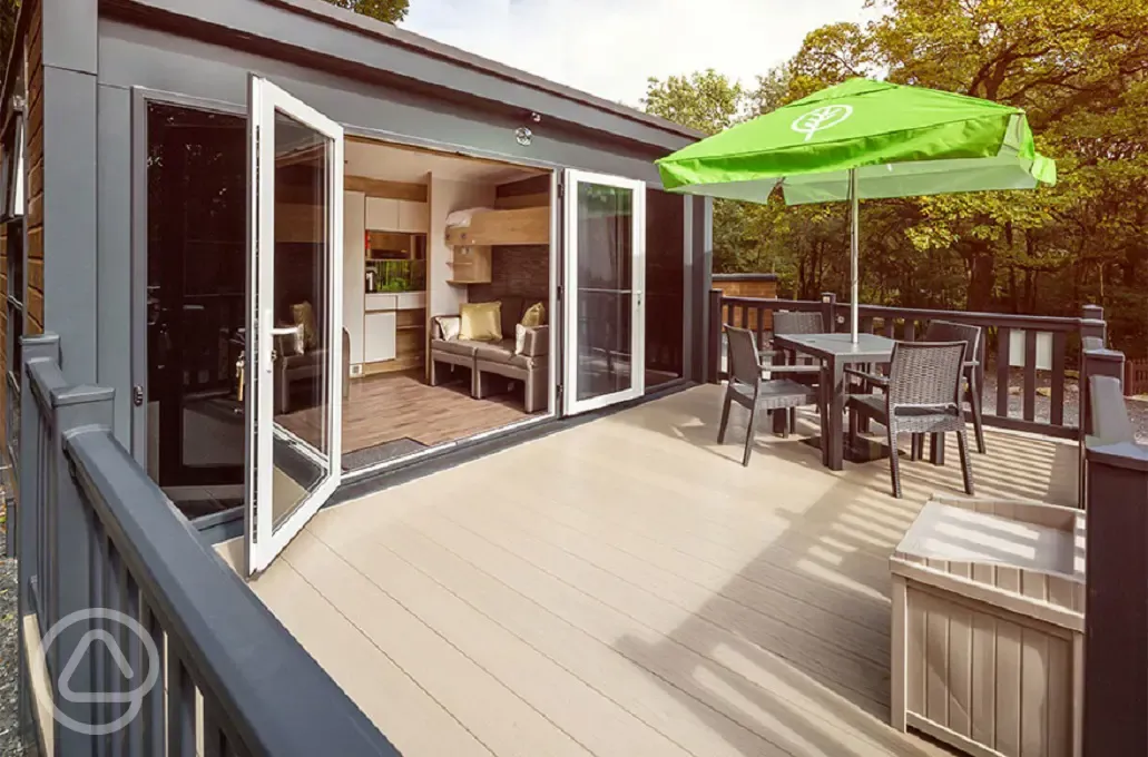 Glamping pod deck area with double glass doors and a box for muddy shoes