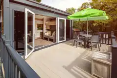Glamping pod deck area with double glass doors and a box for muddy shoes Glamping pod deck area with double glass doors and a box for muddy shoes