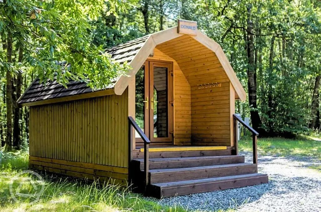 Wooden camping pod with small step access