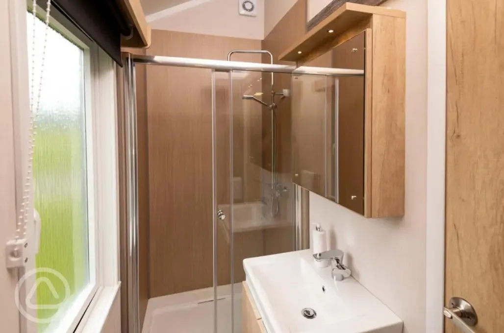 Glamping cabin bathroom with a shower, sink and toilet (bring or hire towels)