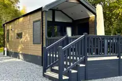 Ensuite glamping cabins with step access and private decks with seating Ensuite glamping cabins with step access and private decks with seating