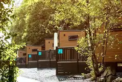 Ensuite glamping pods with raised decking areas and outdoor seating Ensuite glamping pods with raised decking areas and outdoor seating