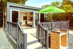 Ensuite glamping pods accessed by a small set of stairs with a brick BBQ Ensuite glamping pods accessed by a small set of stairs with a brick BBQ