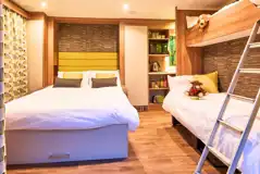 Ensuite glamping pod interior with a double sofa bed, single sofa bed and bunk Ensuite glamping pod interior with a double sofa bed, single sofa bed and bunk