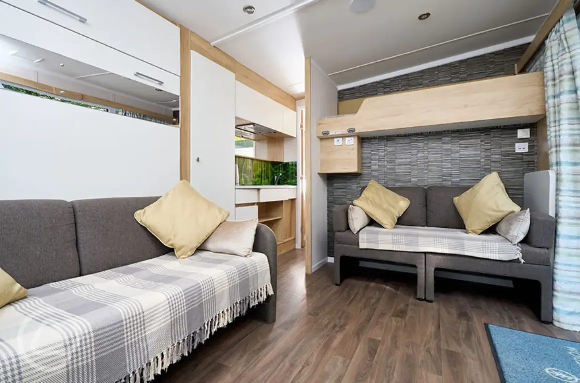 Ensuite glamping pod interior with sofa beds and a bunk (bedding included)