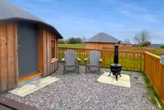 Wooden yurt and outdoor area with a private fire pit