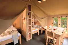 Safari tent with a double bedroom and triple room with single beds and bunk Safari tent with a double bedroom and triple room with single beds and bunk