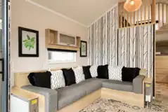 Glamping cabin interior with a large L-shaped sofa bed Glamping cabin interior with a large L-shaped sofa bed