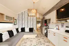 Ensuite glamping cabin interior with a sofa bed and mezzanine level Ensuite glamping cabin interior with a sofa bed and mezzanine level