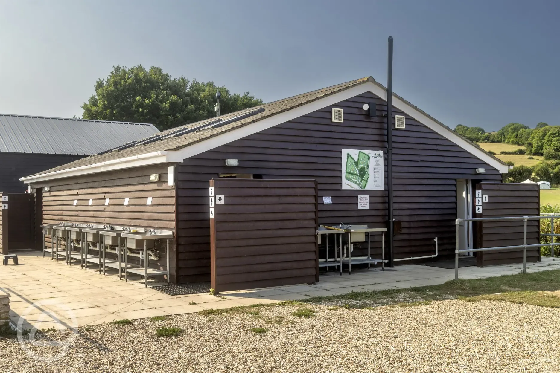 Unisex facilities block with an outdoor washing up area