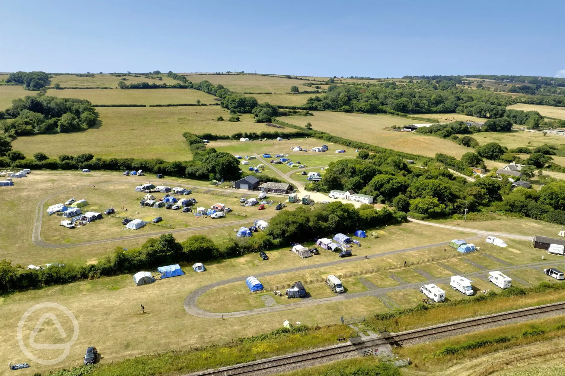 Aerial of the grass and hardstanding pitches at Woodyhyde Campsite