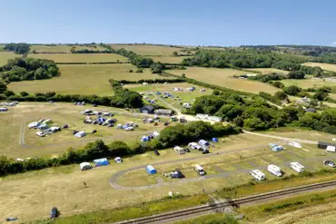 Aerial of the grass and hardstanding pitches at Woodyhyde Campsite