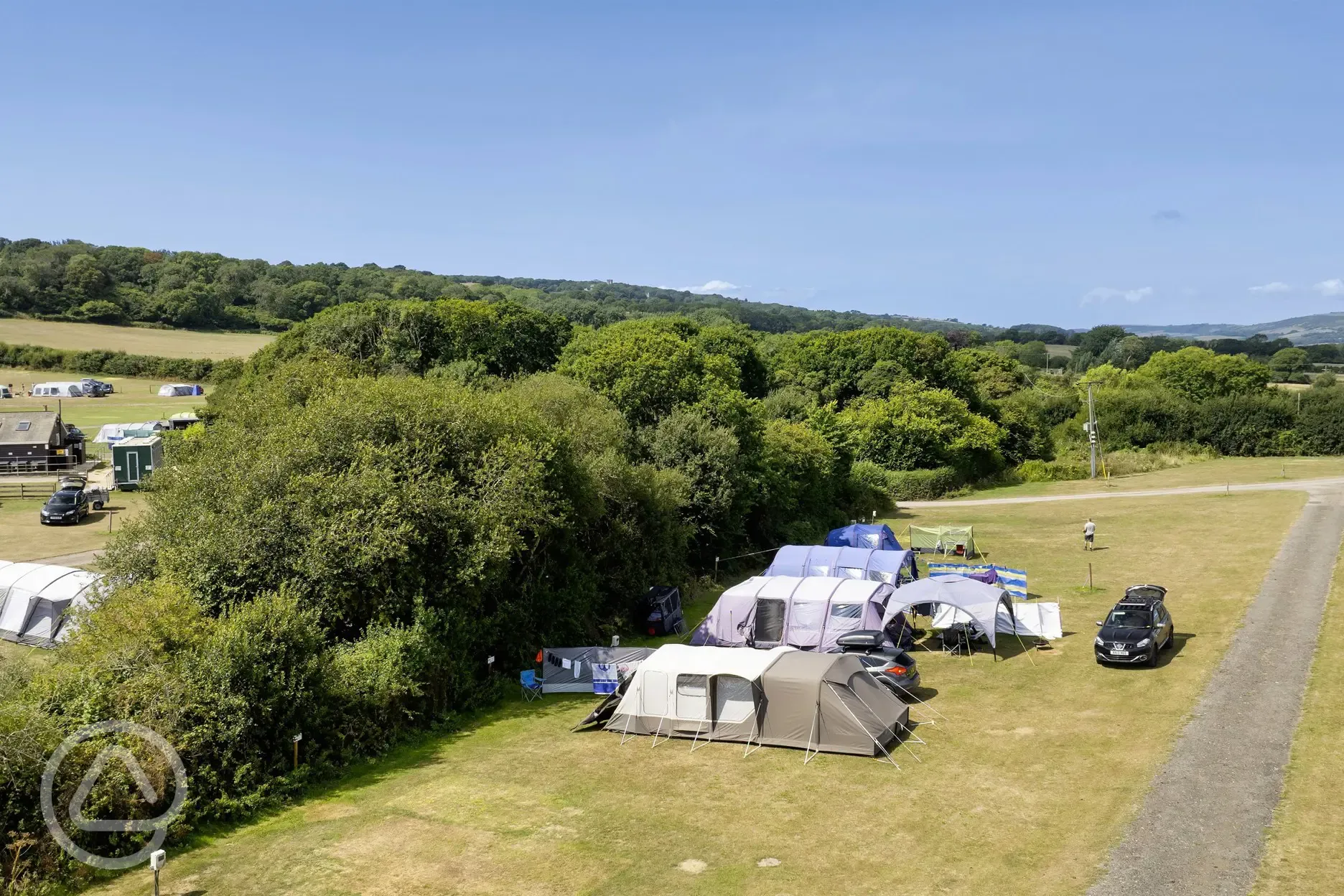 Camping field with a parked car beside
