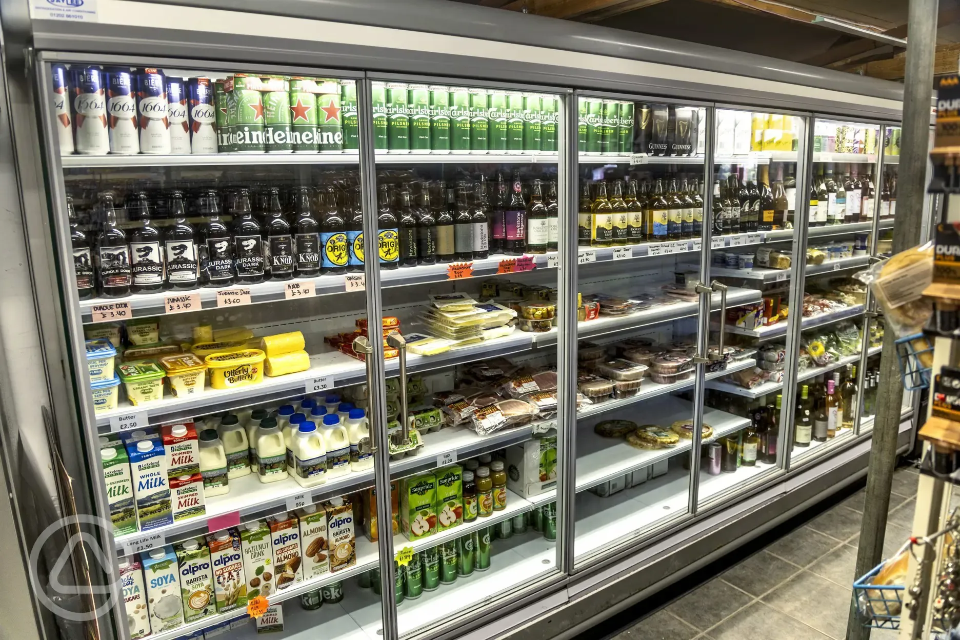 Local beers, dairy, and cold food sold inside the shop