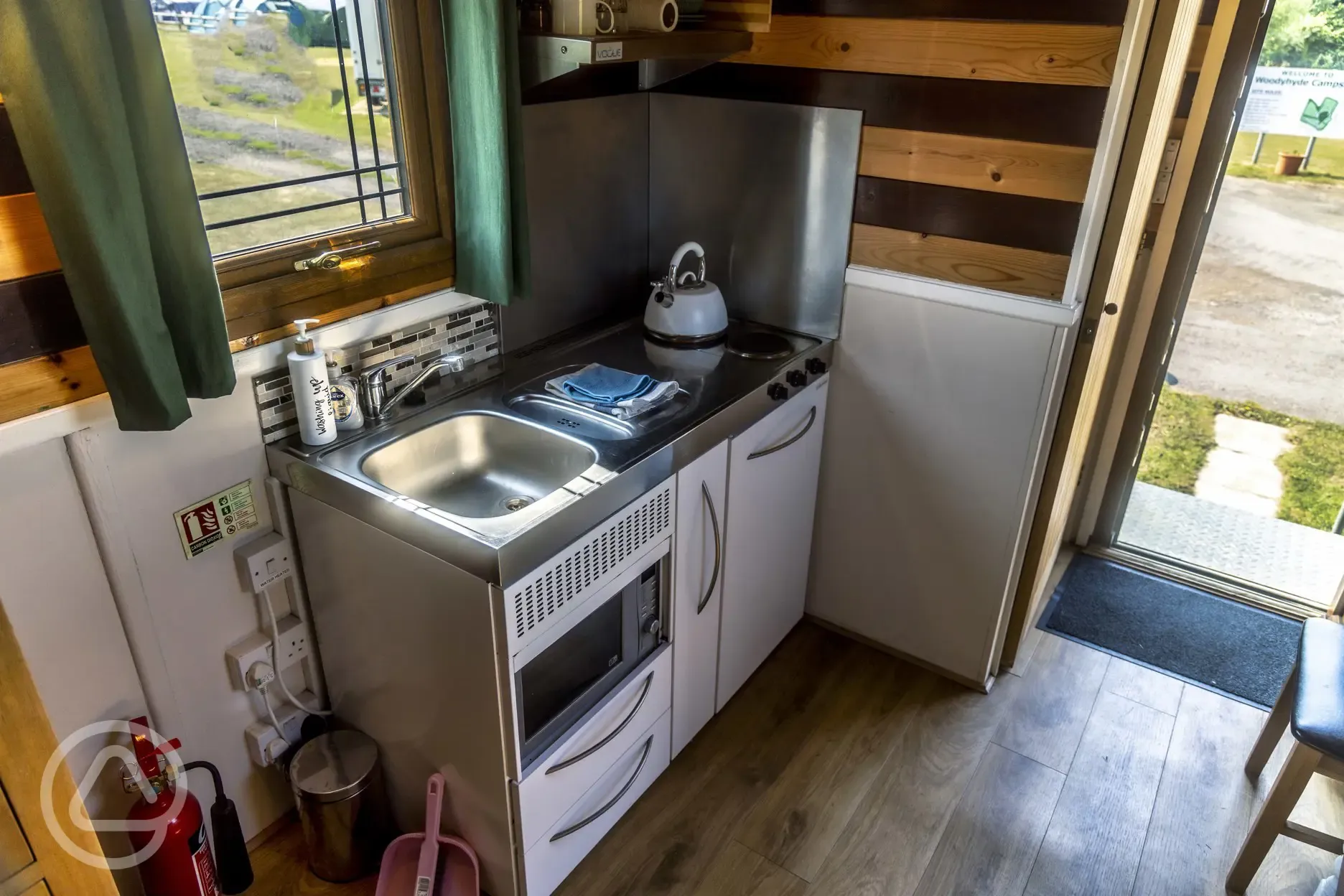 Shepherd's hut kitchenette with a sink, hob, and kettle