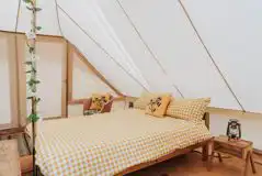 Bell tent with a double bed with bedding and extra camp beds (bring bedding)