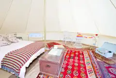 Bell tent with a double bed with bedding and extra camp beds (bring bedding)