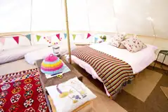 Bell tent with a double bed with bedding and extra camp beds (bring bedding)