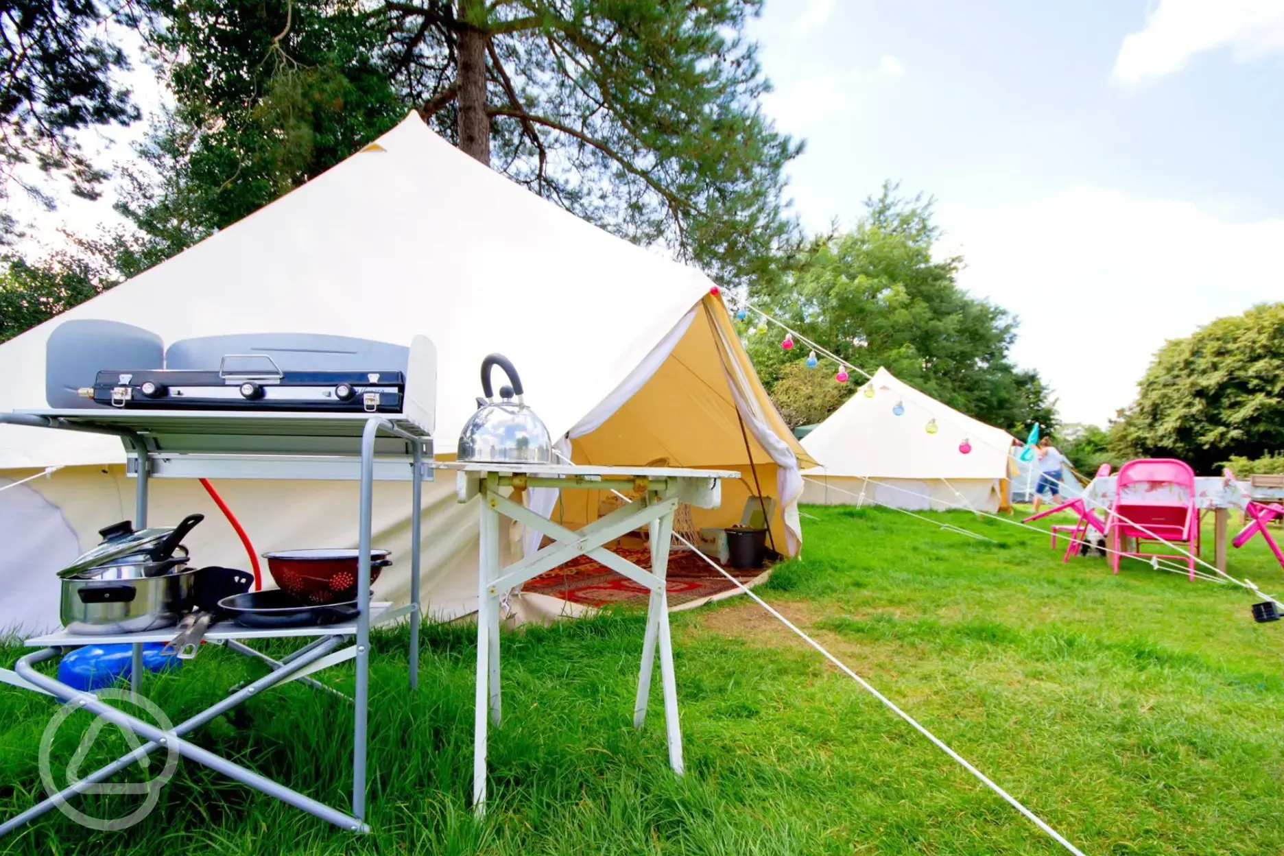 Bell tent outdoor kitchen area with a camping stove