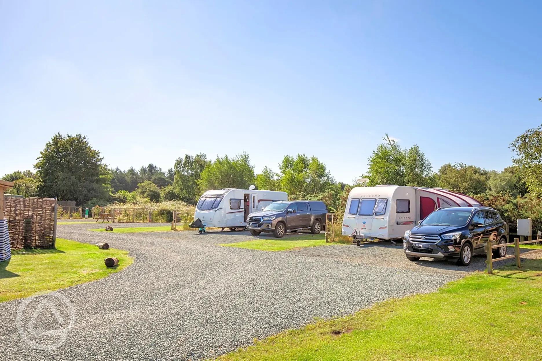 Fully serviced hardstanding pitches surrounded by trees