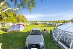 Small electric grass pitches (Sandy Acres) with space to park next to your pitch