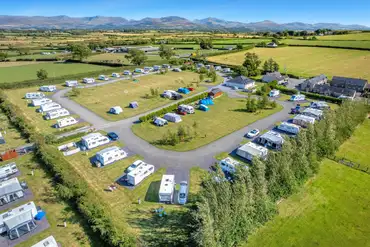Aerial of non electric grass pitches and fully serviced hardstanding pitches