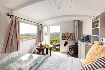 The Shepherd's Hut interior at Hideaway Huts with countryside views
