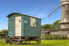 External view of Ryeland shepherd's hut with mill in the distance