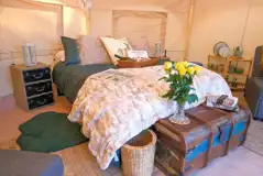 Bell tent interior with furnishings and cutlery and crockery for four