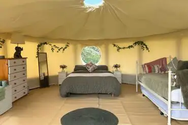 Willow yurt (dog friendly) with a double bed and day bed at Pitch and Canvas
