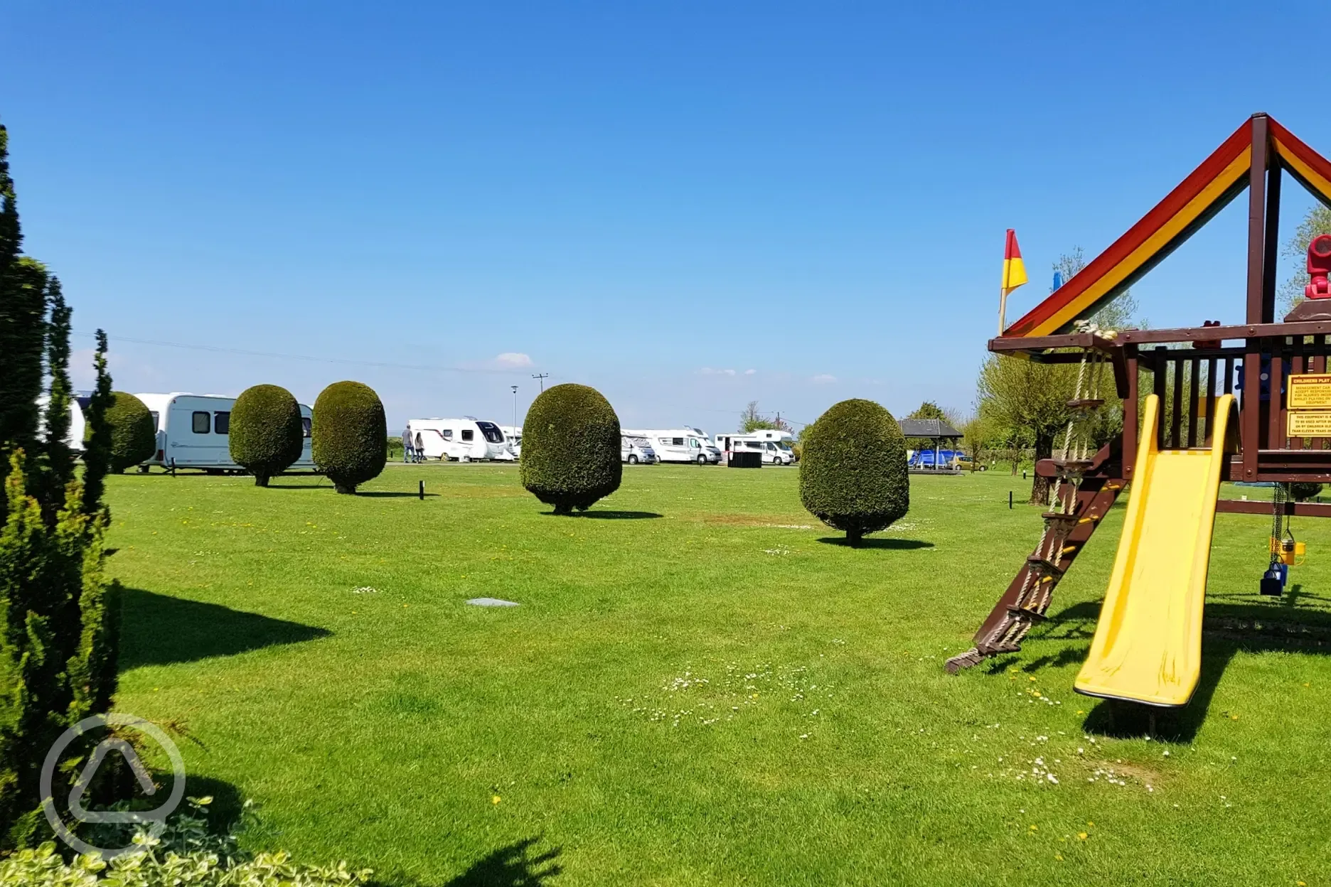 Play park with swings, a slide, climbing wall, rope and step ladder