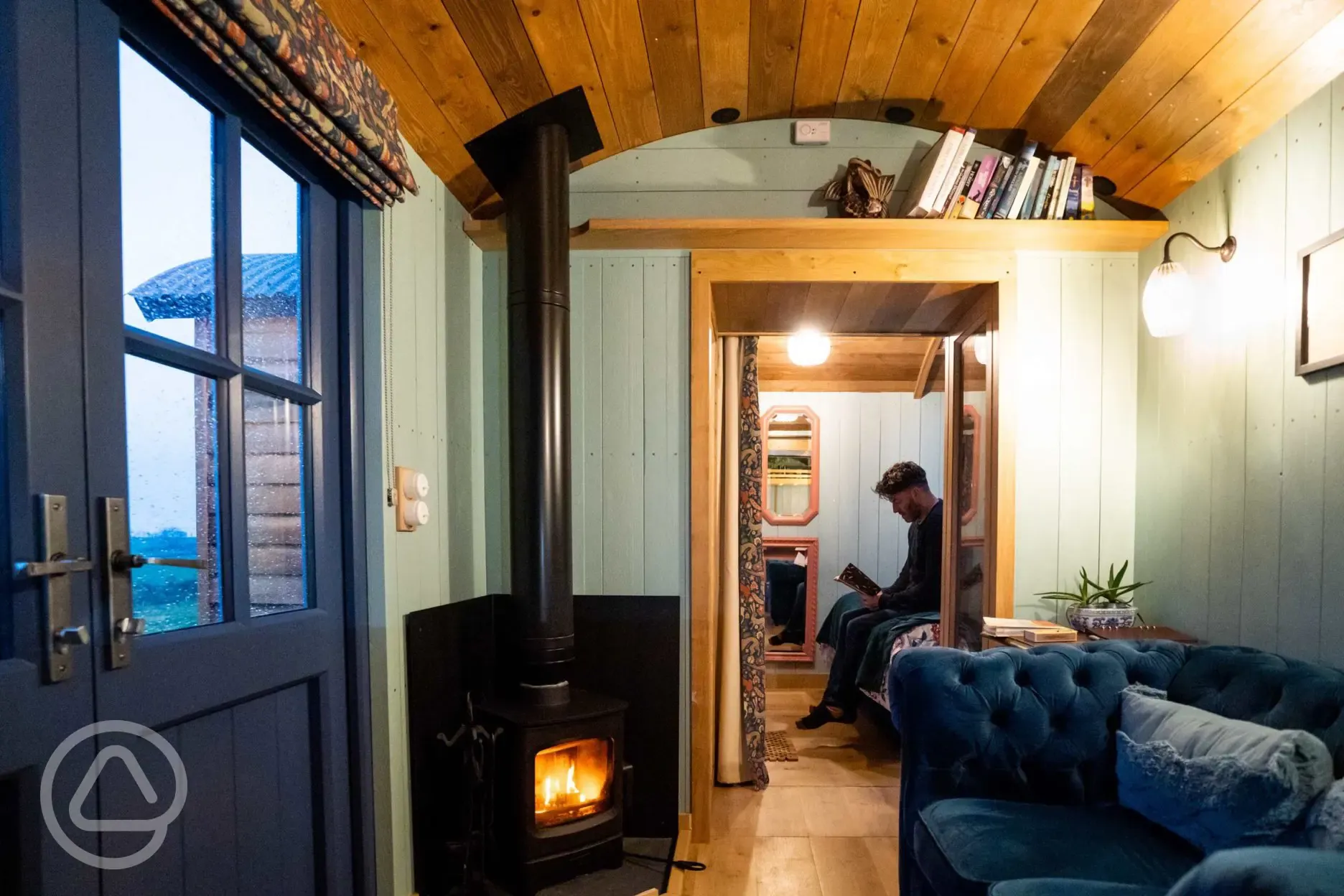Novelist shepherd's hut wood burner and lounge area