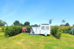 Large grass pitches with hedging on either side