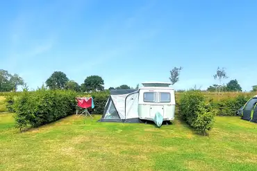 Large grass pitches with hedging on either side