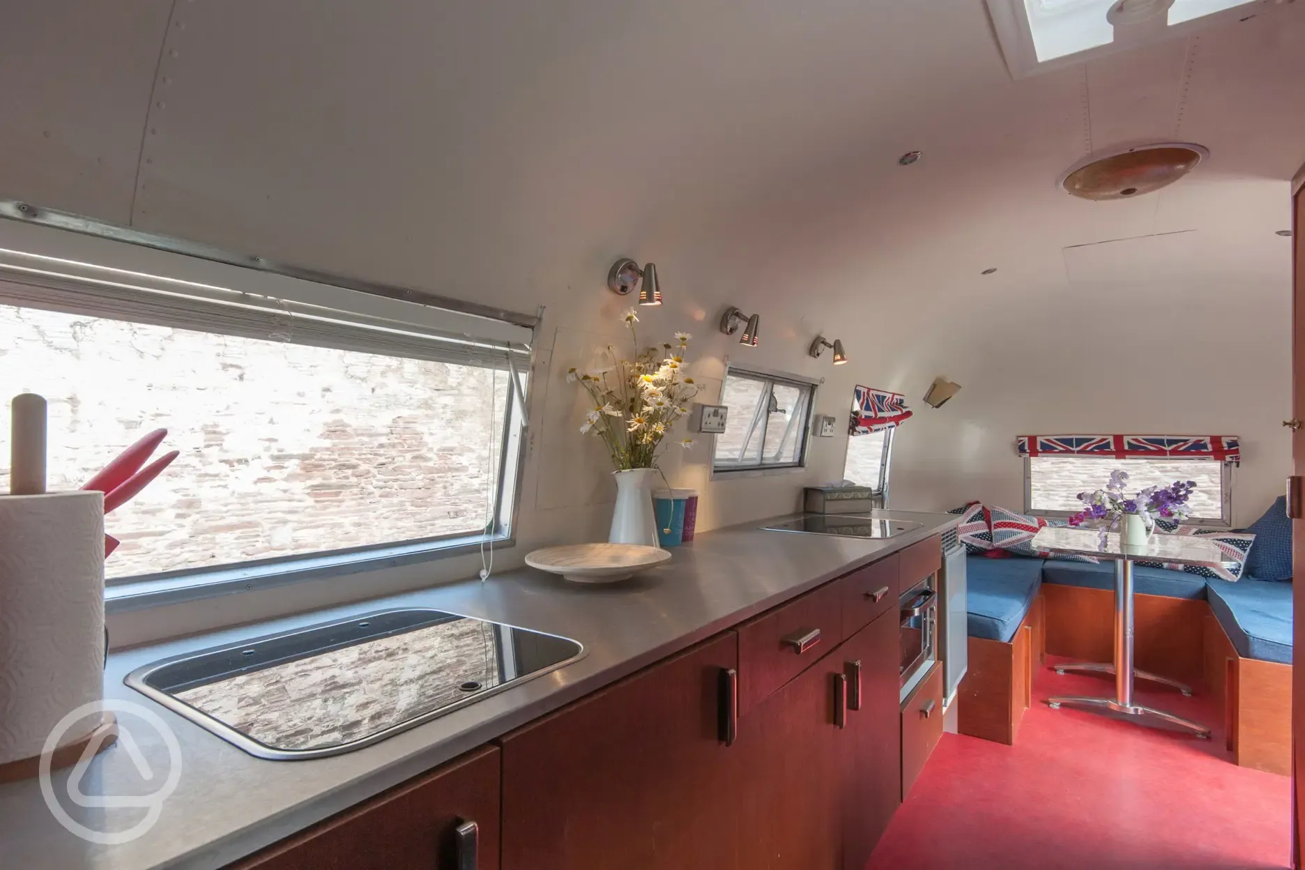 Airstream has an onboard kitchen and flushing toilet.